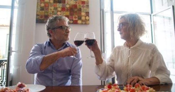Womans hand rejecting more alcohol from wine bottle in bar