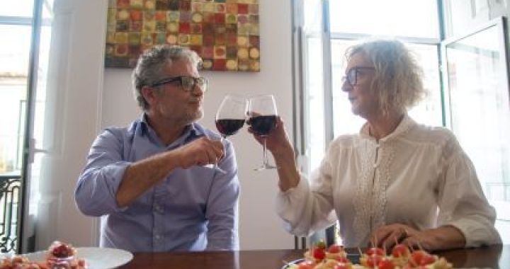 Womans hand rejecting more alcohol from wine bottle in bar