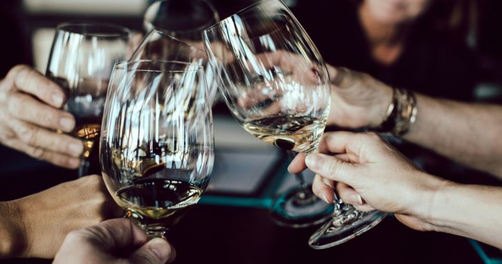 Womans hand rejecting more alcohol from wine bottle in bar